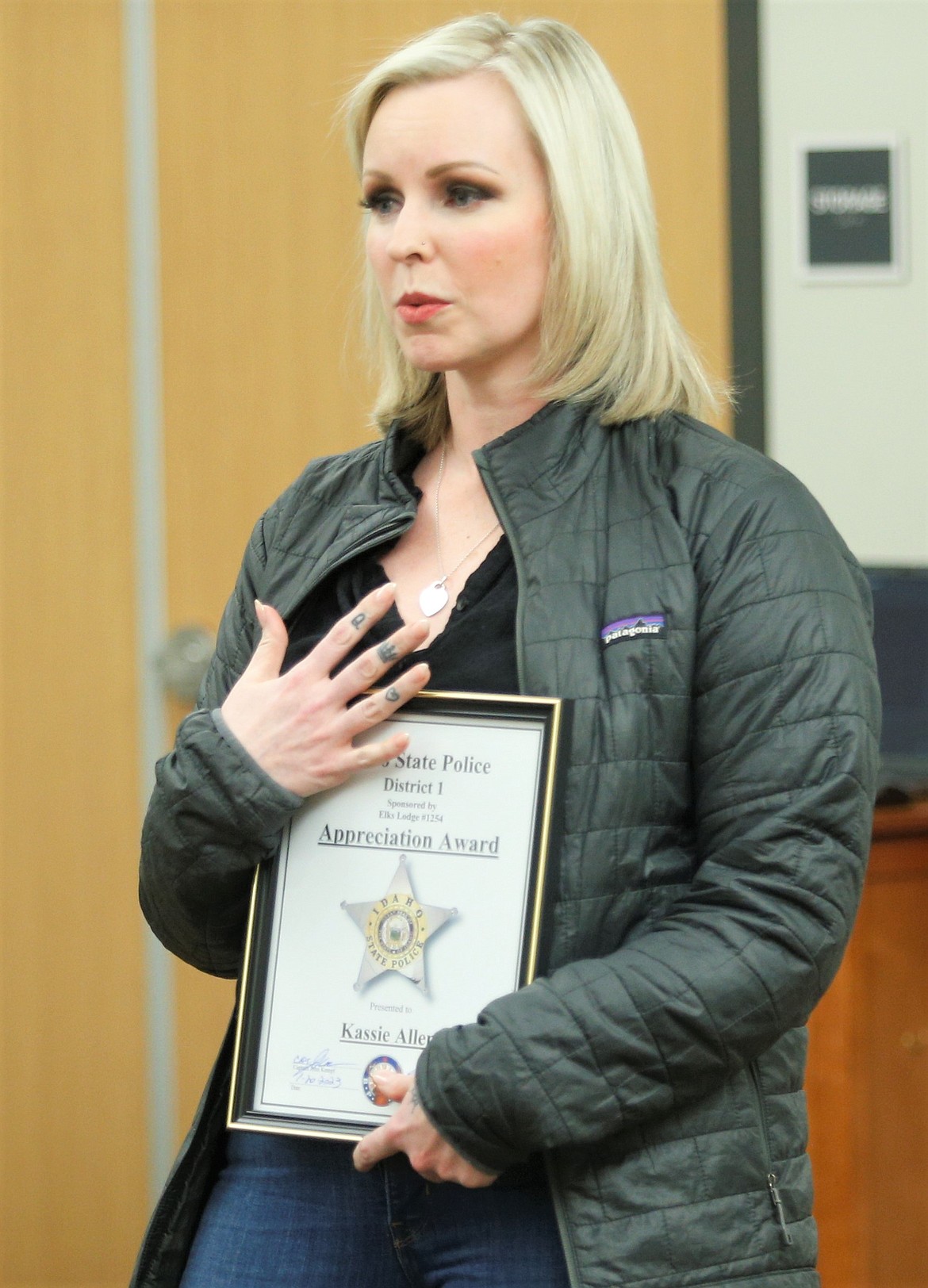 Kassie Allen holds the Idaho State Police District 1 Appreciation Award she received on Friday.