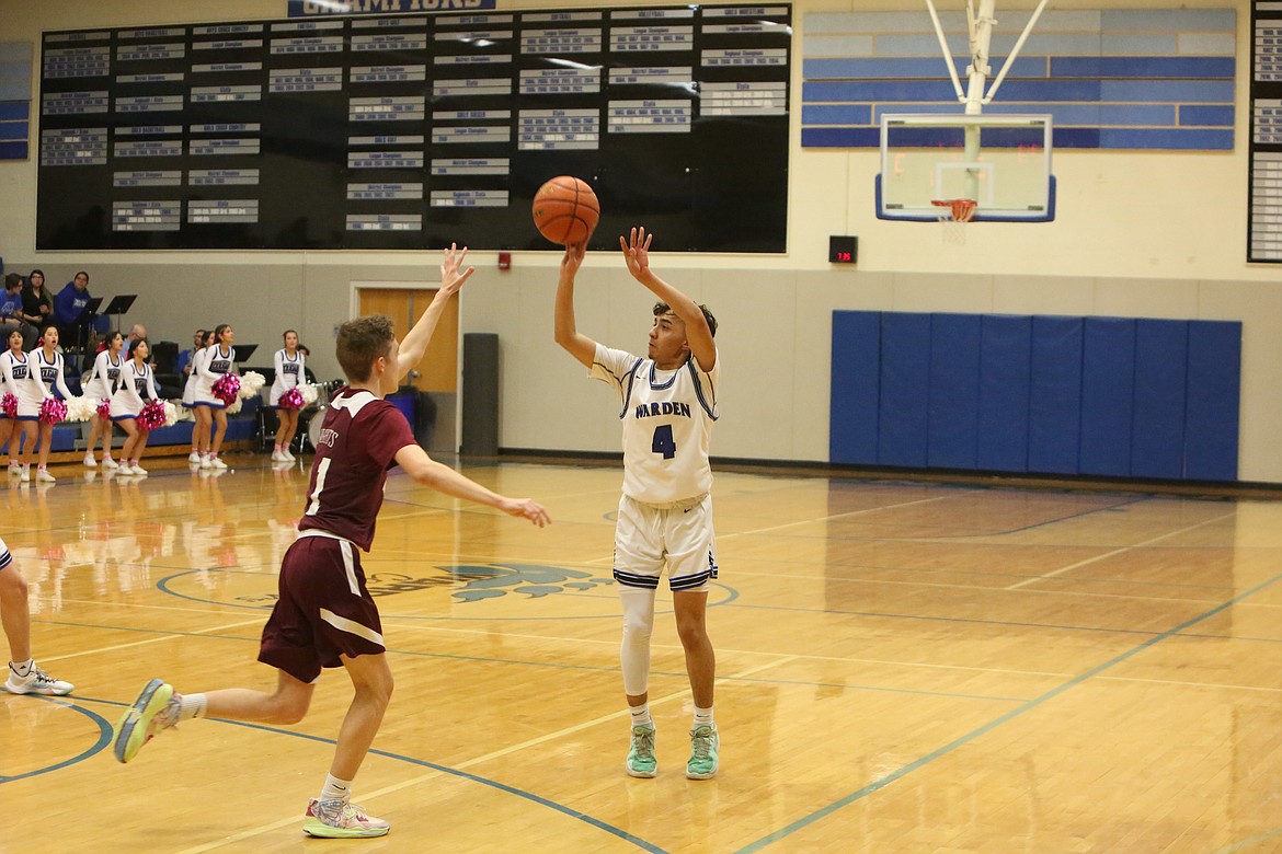 With a defender running toward him, Warden’s Javier Oronia attempts a three-pointer in the first quarter against Walla Walla Valley.