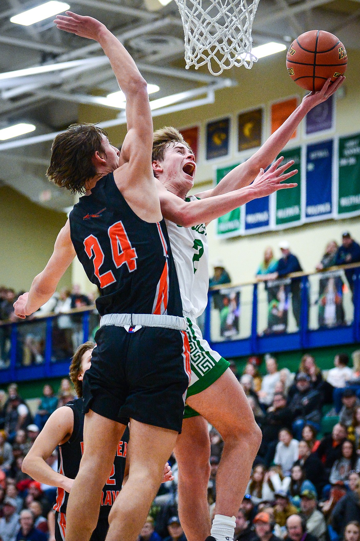Glacier's Tyler McDonald (2) is fouled on his way to the basket by Flathead's Lyric Ersland (24) in the first half during crosstown basketball at Glacier High School on Friday, Jan. 20. (Casey Kreider/Daily Inter Lake)