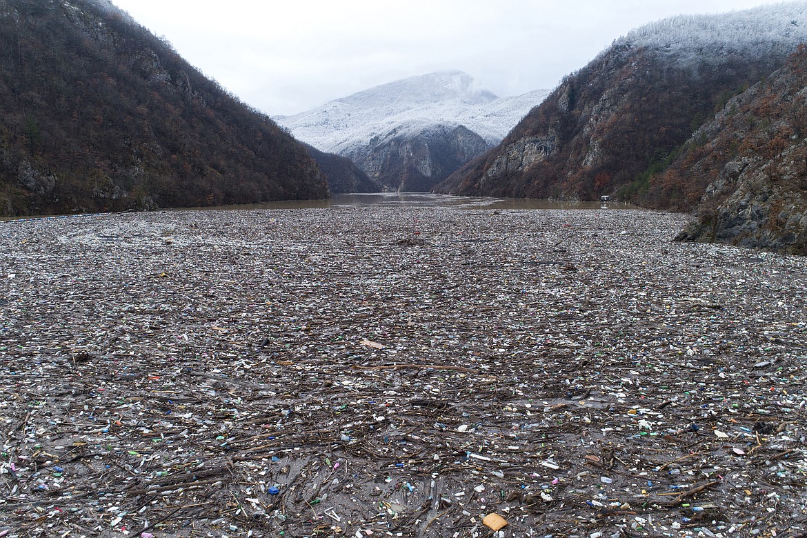 Waste floating in the Drina river near Visegrad, Bosnia, Friday, Jan. 20, 2023. Tons of waste dumped in poorly regulated riverside landfills or directly into the rivers across three Western Balkan countries end up accumulating during high water season in winter and spring, behind a trash barrier in the Drina River in eastern Bosnia. (AP Photo/Armin Durgut)