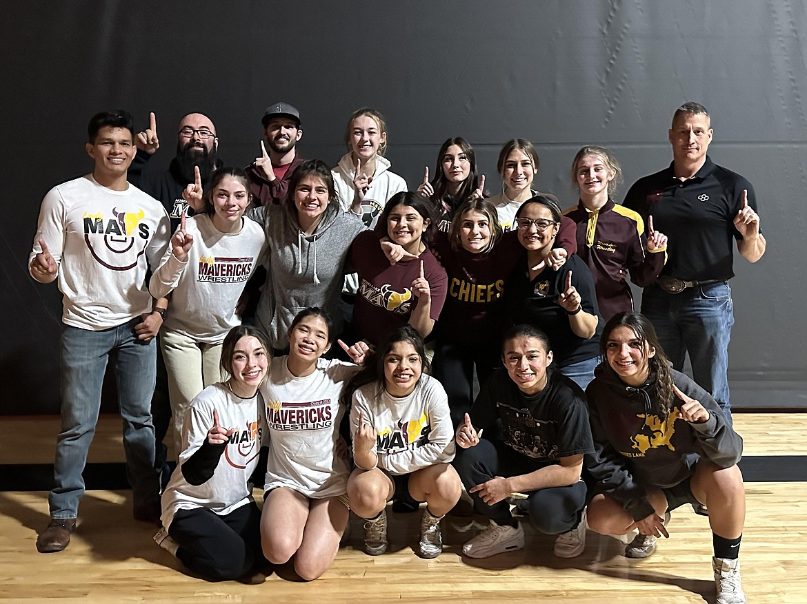 The Moses Lake girls wrestling team poses for photos after defeating Davis 42-30 on Thursday, winning the Columbia Basin Big 9 title.