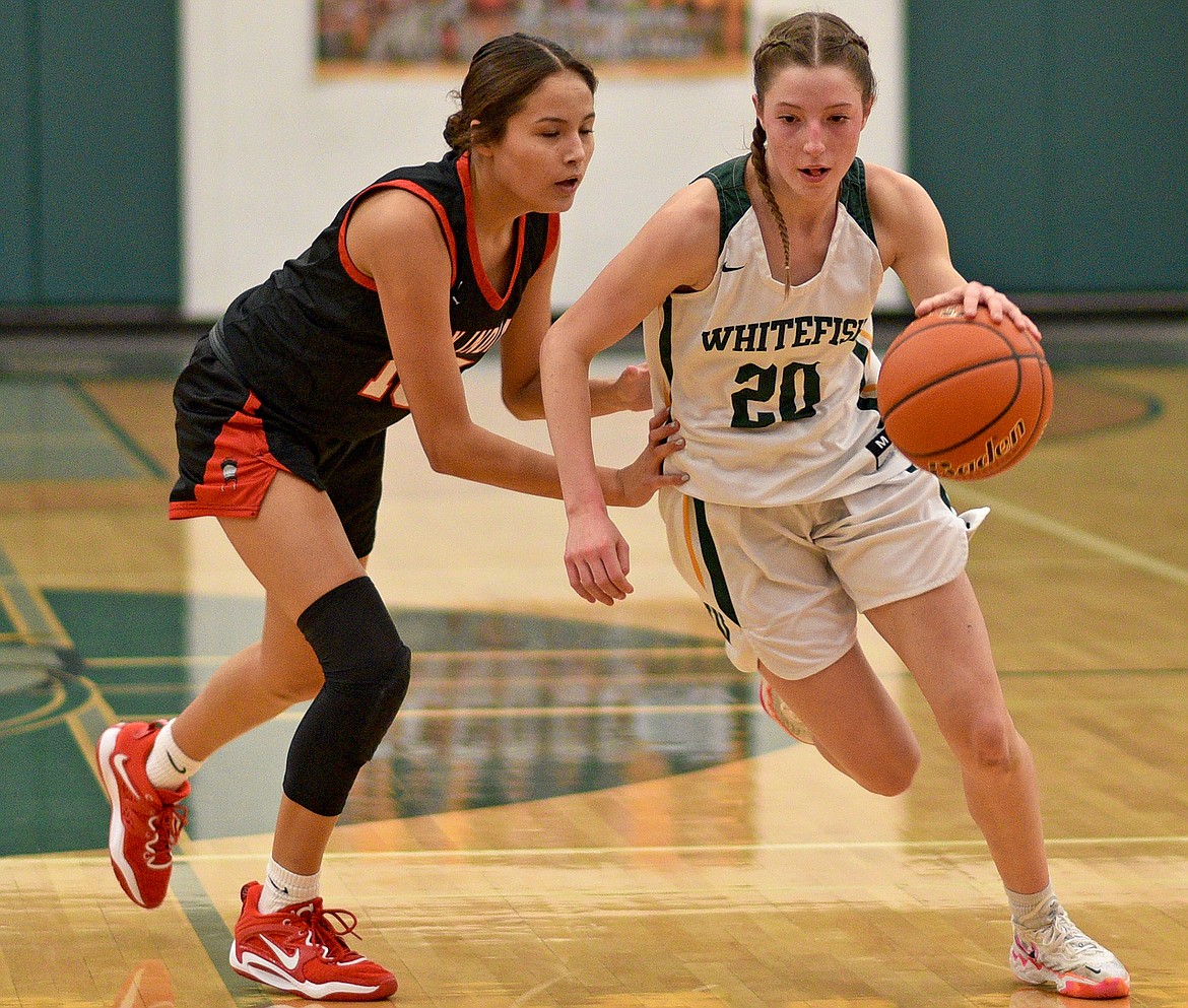 Bulldog Hailey Ells takes the ball down the court during a game against Browning on Saturday in Whitefish. (Whitney England/Whitefish Pilot)