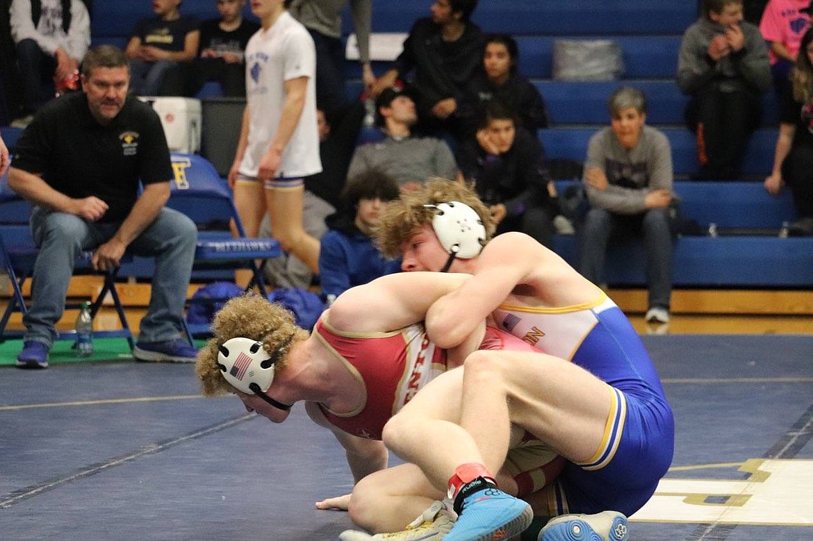 Thompson Falls wrestler Eli Ratliff (blue) gains control in his match in the 160-pound division at the Ted Kato event this past Saturday in T Falls.  Ratliff won the individual title at 160 pounds.  (Photo by Kami Milender)