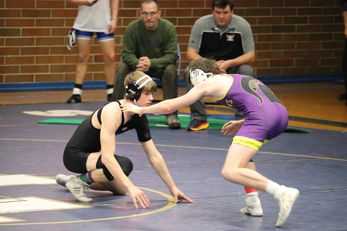 Plains/Hot Springs' John Waterbury (black) looks for an opening to take down an opponent from Missoula Sentinel on his way to winning the 132 pound championship at the Ted Kato event. (Photo by Kami Milender)