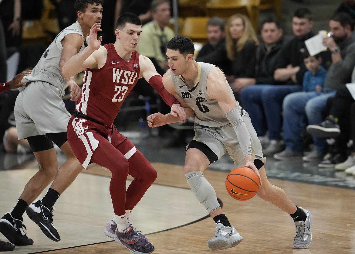 Colorado guard Luke O'Brien, right, drives to the rim as Washington State forward Andrej Jakimovski defends in the first half of an NCAA basketball game, Sunday, Jan. 22, 2023, in Boulder, Colo.