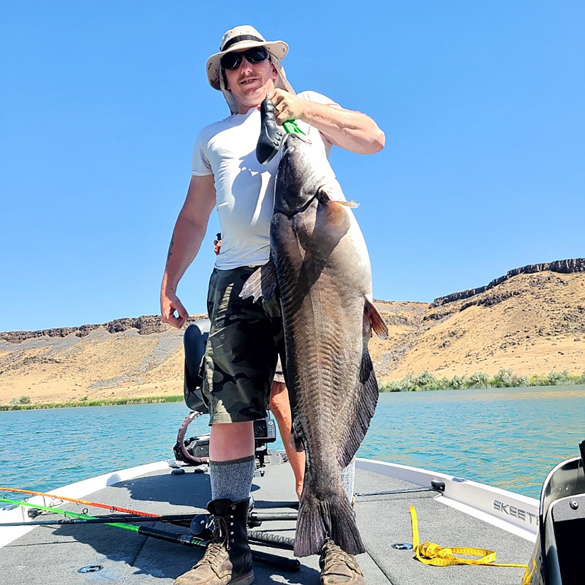 Fruitland angler Paul Newman poses with a blue catfish that set an Idaho record at 42.5-inch long.