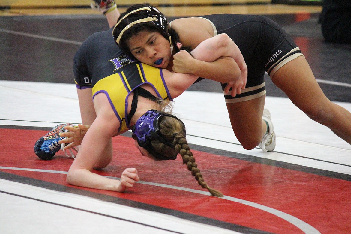 Royal’s Sharon Arroyo works to turn her opponent, Ayden Foreman of Hermiston, during a match Saturday at the Lady Huskie Invitational in Othello.