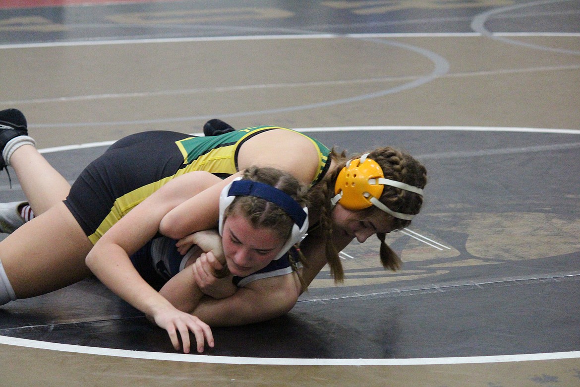 Jourdan Ferguson, of Quincy, works to turn her opponent, Ava Thomas of Glacier Peak. The wrestlers were competing in the Lady Huskie Invitational in Othello.