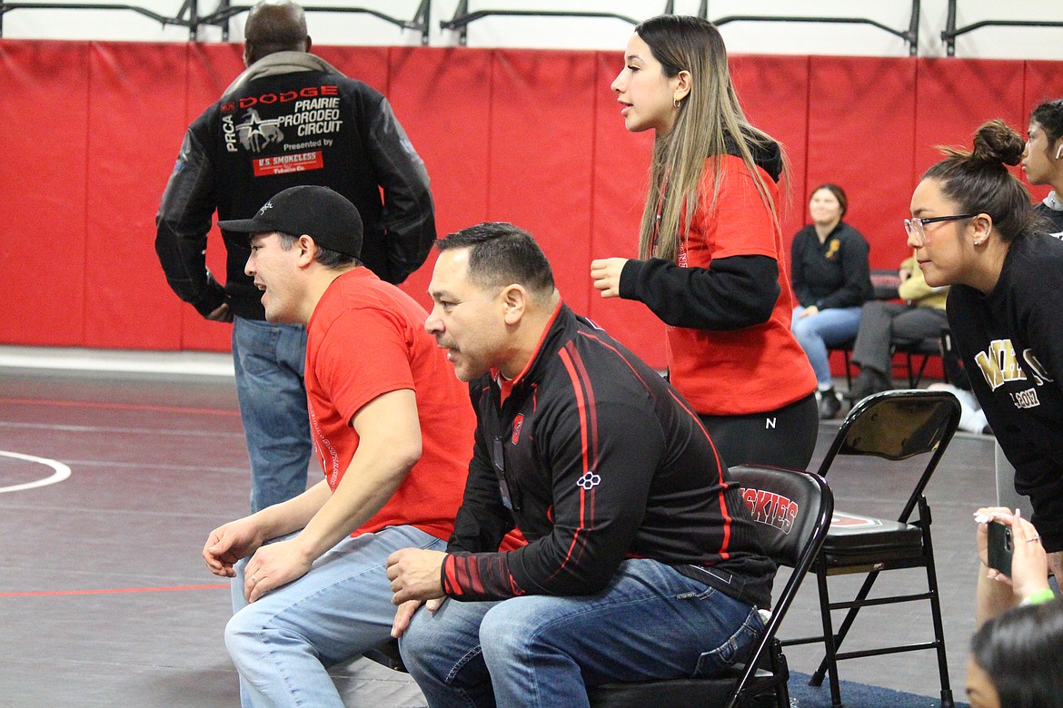 Othello Head Coach Rafael Ruiz, foreground, and the coaching staff concentrate on a match.