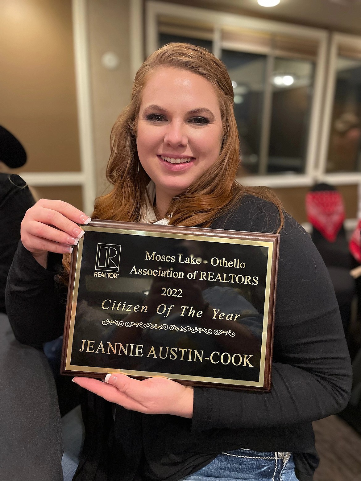 Jeannie Austin-Cook stops for a photo with her plaque recognizing her for her work in the community. She was nominated for the award by Allison May of Better Homes and Gardens Gary Mann Real Estate in Moses Lake.