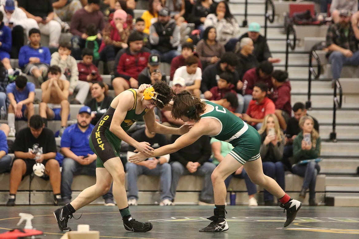 Quincy freshman Diego Diaz, left, takes on a Chelan wrestler at Saturday’s Quincy Mat Animal Invitational.