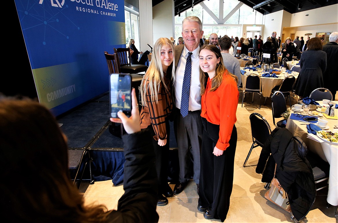 Gov. Brad Little poses for a picture with Lake City High School students Ariana Aalto, left, and Piper Stephens following his talk before the Coeur d'Alene Regional Chamber at the Hagadone Event Center on Tuesday.