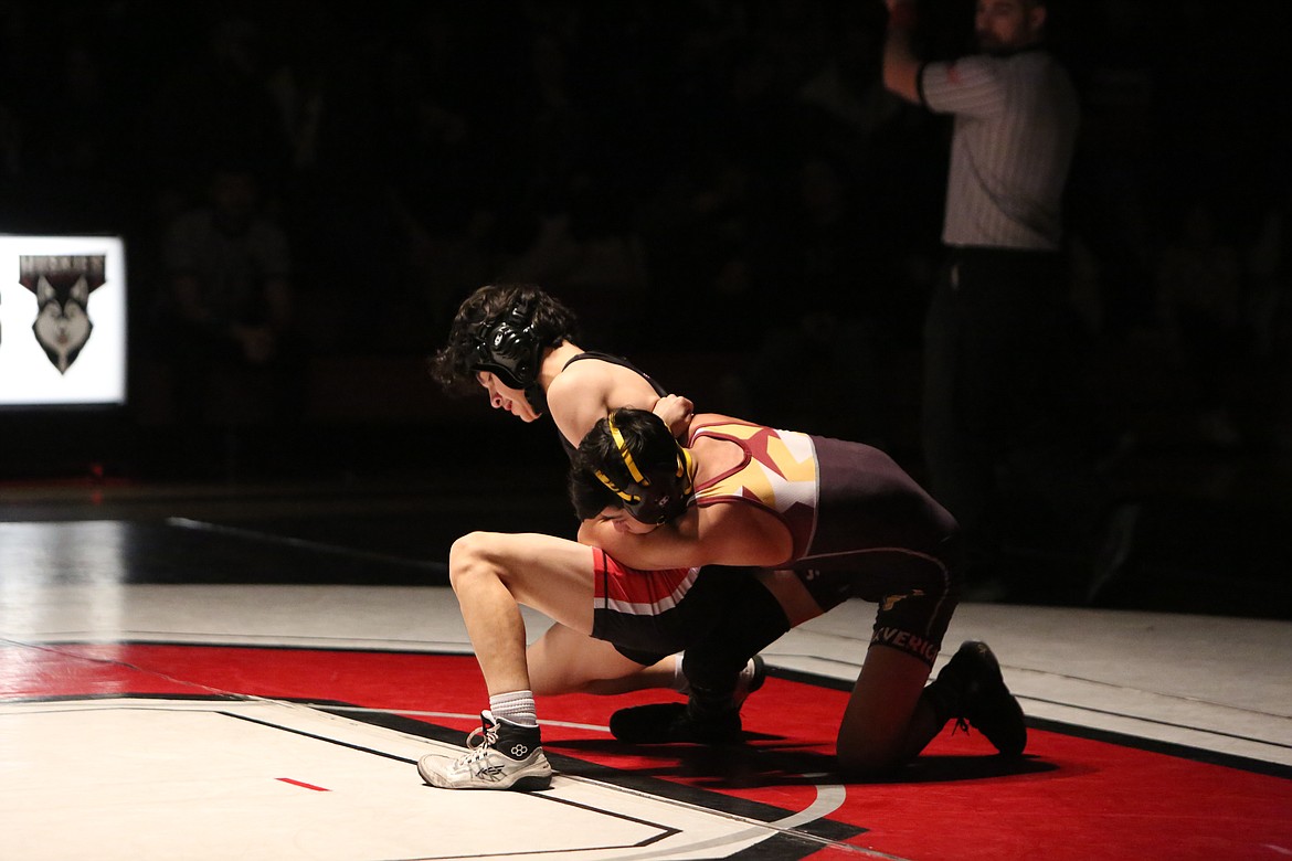 Othello sophomore Christopher Garcia, left, placed eighth in the 106 weight class at the Rumble in the Valley tournament last weekend. Moses Lake freshman Ian Garza, right, placed second.