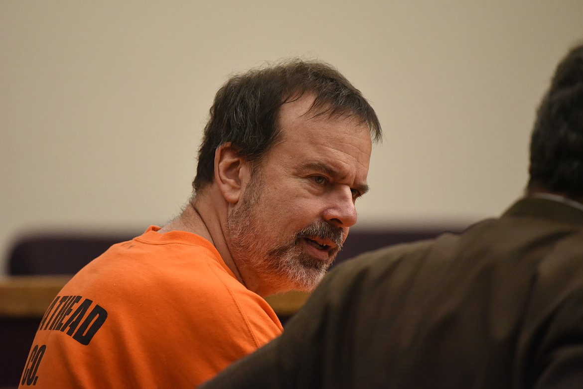 Nicholas Oberling speaks with defense attorney Sean Hinchey during the landscape painter's Jan. 25 sentencing in Flathead County District Court. (Derrick Perkins/Daily Inter Lake)