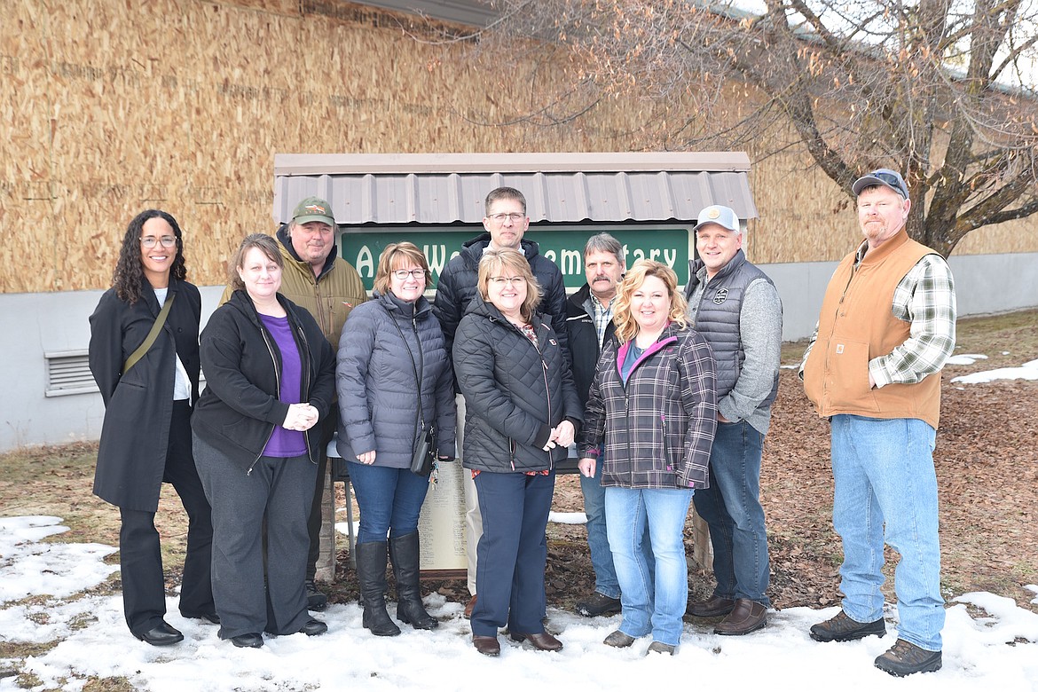 Libby Public School officials and the new owners of the former Asa Wood School property, Compass Health, posed for a photo Wednesday afternoon.(Scott Shindledecker/The Western News)