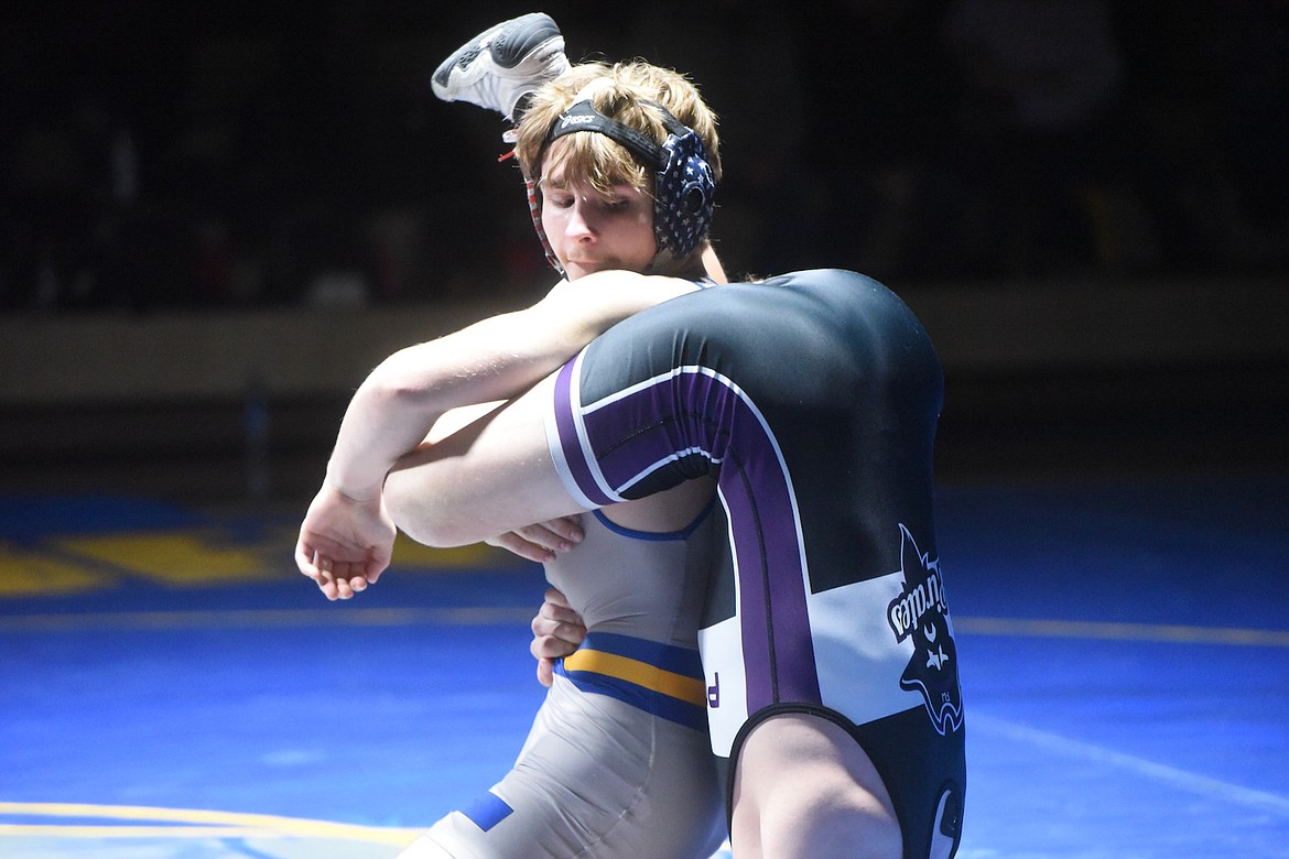 Libby's Joey Wise battled Polson's Daniel Peterson at 152 pounds during Tuesday's match. (Scott Shindledecker/The Western News)