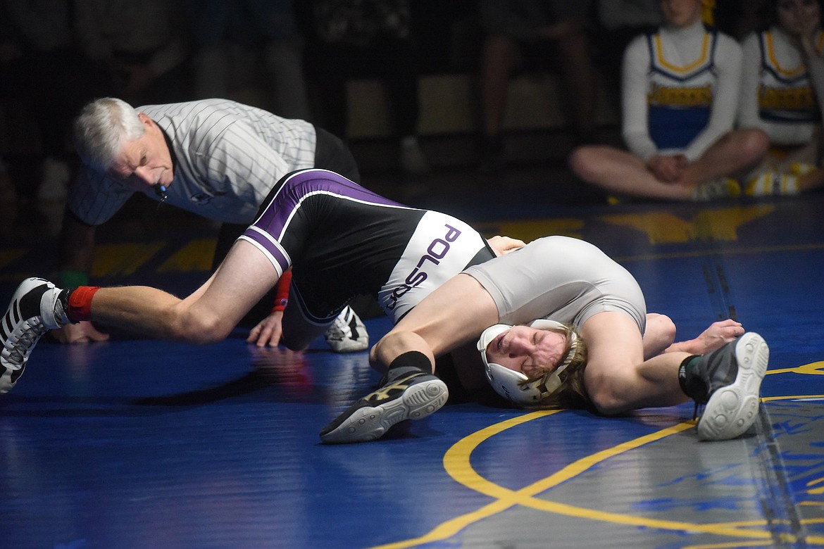 Libby's Marley Erickson pinned Polson's Michah Craig at 132 pounds during Tuesday's match. (Scott Shindledecker/The Western News)