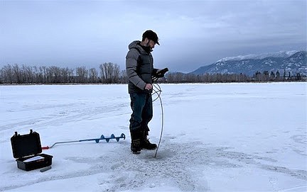 Montana Fish, Wildlife and Parks Fisheries Biologist Kenny Breidinger studies the dissolved oxygen concentration in McWenneger Slough near Evergreen on Jan. 5. (FWP photo)