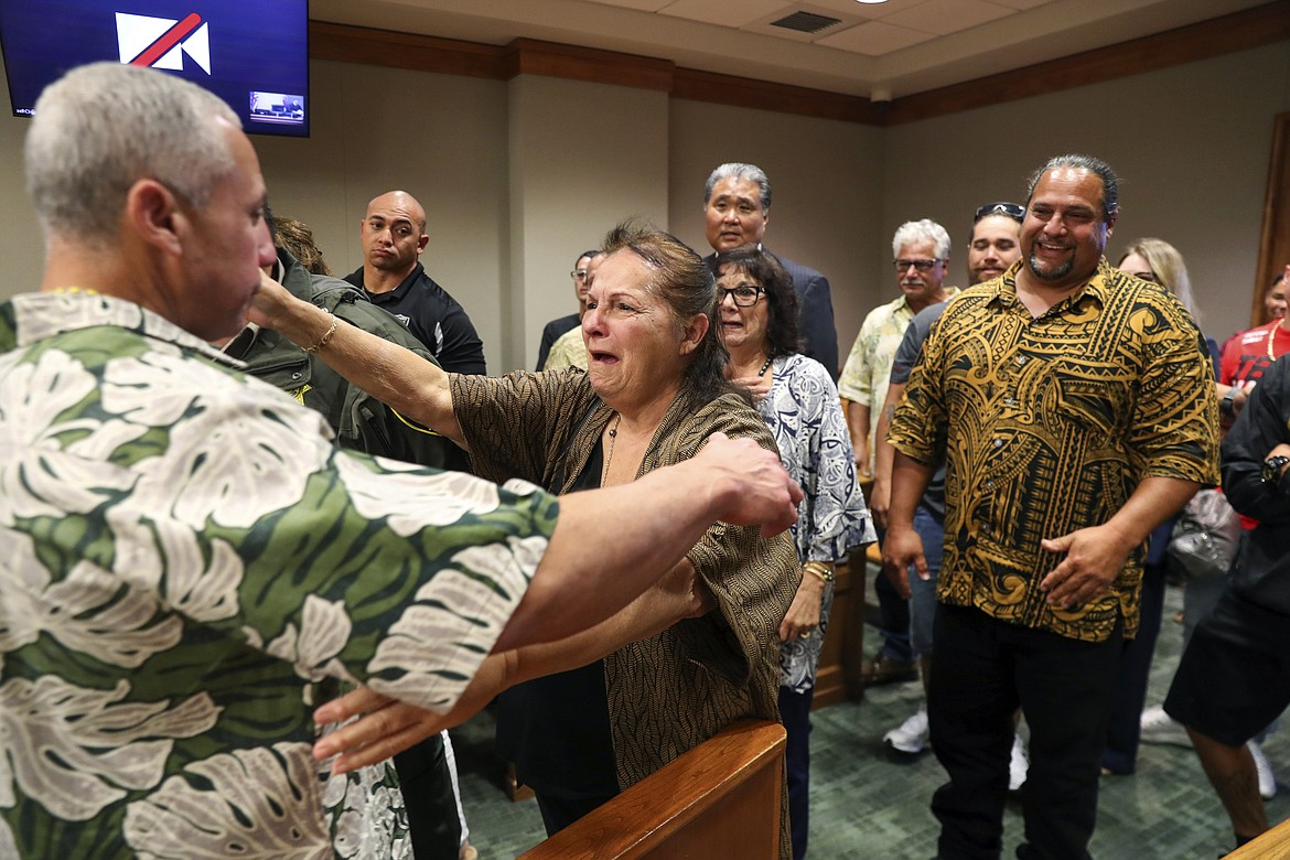 Albert "Ian" Schweitzer, left, hugs his mother, Linda, moments after a judge ordered him released from prison, in Hilo, Hawaii, Tuesday, Jan. 24, 2023. The judge's ruling came immediately after Schweitzer's attorneys presented new evidence and argued that Schweitzer didn’t commit the crimes he was convicted of and spent more than 20 years locked up for: the 1991 murder, kidnapping and sexual assault of a woman visiting Hawaii. (Marco Garcia/The Innocence Project via AP Images)