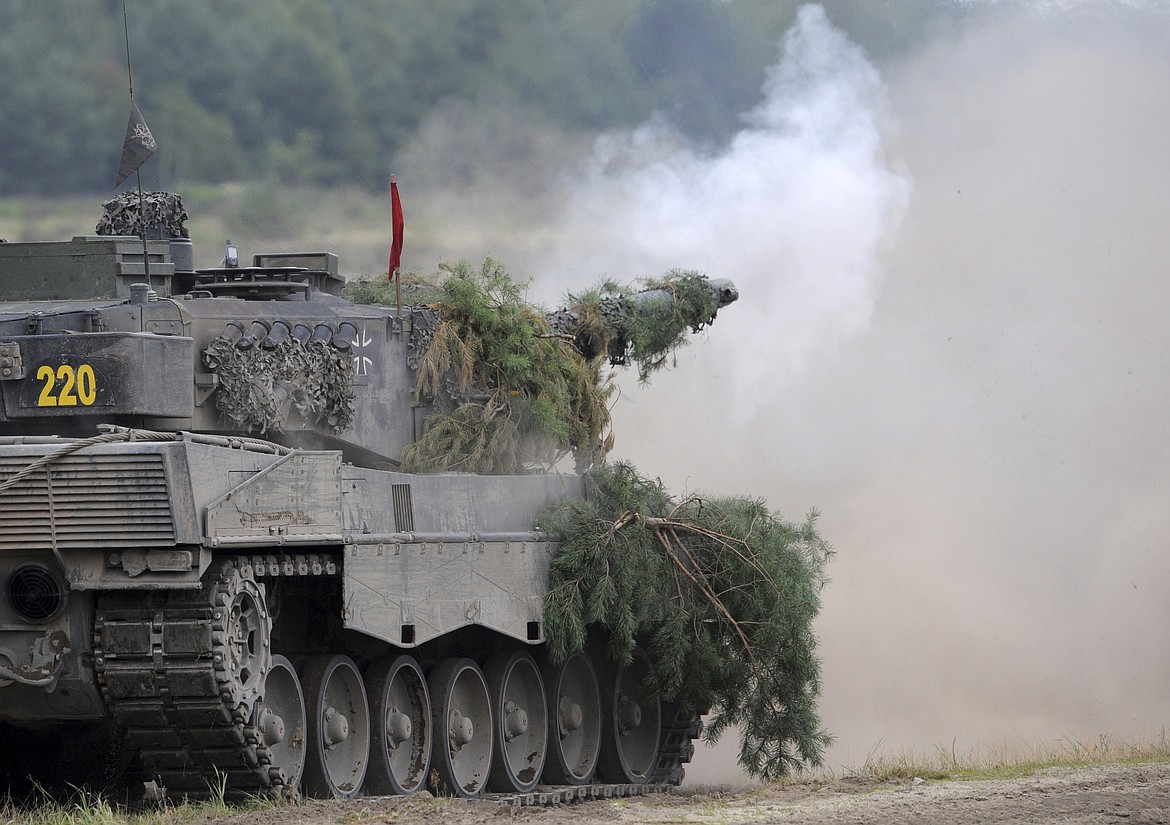 A Leopard 2A6 tank from the Bundeswehr's Panzer exercise bataillon 93 fires at the Oberlausitz training area in Weisskeissel, Germany, Aug. 12, 2009. The German government has confirmed it will provide Ukraine with Leopard 2 battle tanks and approve requests by other countries to do the same. Chancellor Olaf Scholz said Wednesday that Germany was “acting in close coordination” with its allies. (Ralf Hirschberger/dpa via AP, file)