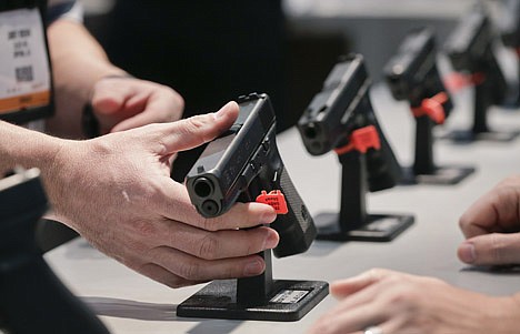 Thinking of buying a firearm? National Rifle Association certified instructors will teach gun safety classes at Farragut Shooting Range in Athol on Feb. 4. 
Pictured, a Glock representative explains features of the Glock 37 Gen 4 .45 caliber pistol.