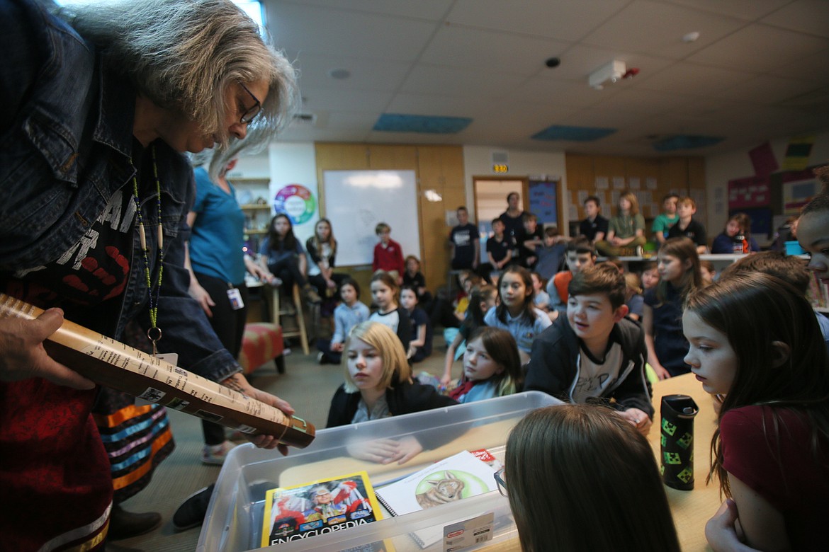 Sorensen Magnet School of Humanities fourth graders are curious about materials in Sarai Mays' teaching trunk as she visits the school Wednesday to share resources and stories about Indigenous people.