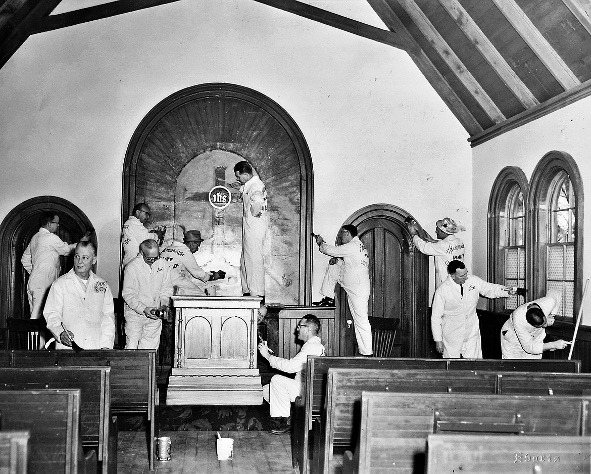 In 1961, members of the old Hydromaniacs refresh the interior of the Fort Sherman Chapel.