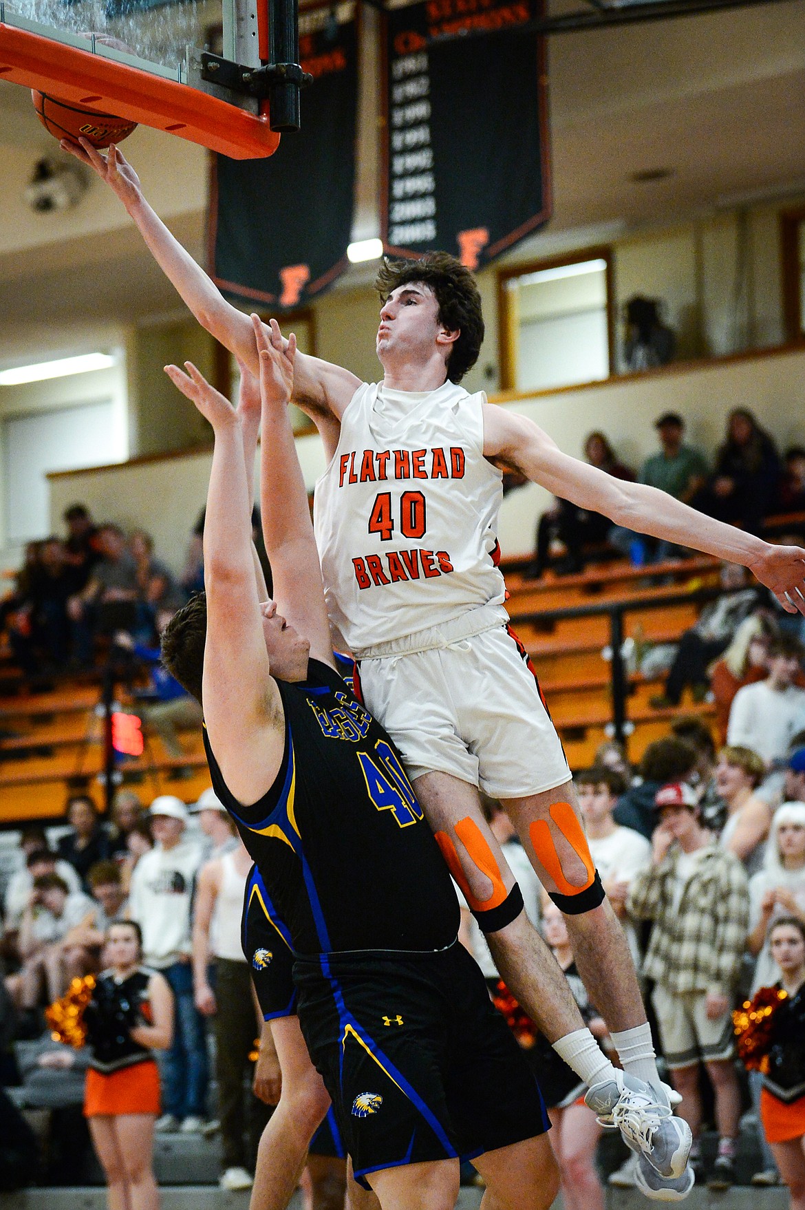 Flathead's Noah Cummings (40) drives to the basket in the third quarter against Missoula Big Sky's Aidan Beard (40) at Flathead High School on Thursday, Jan. 26. (Casey Kreider/Daily Inter Lake)