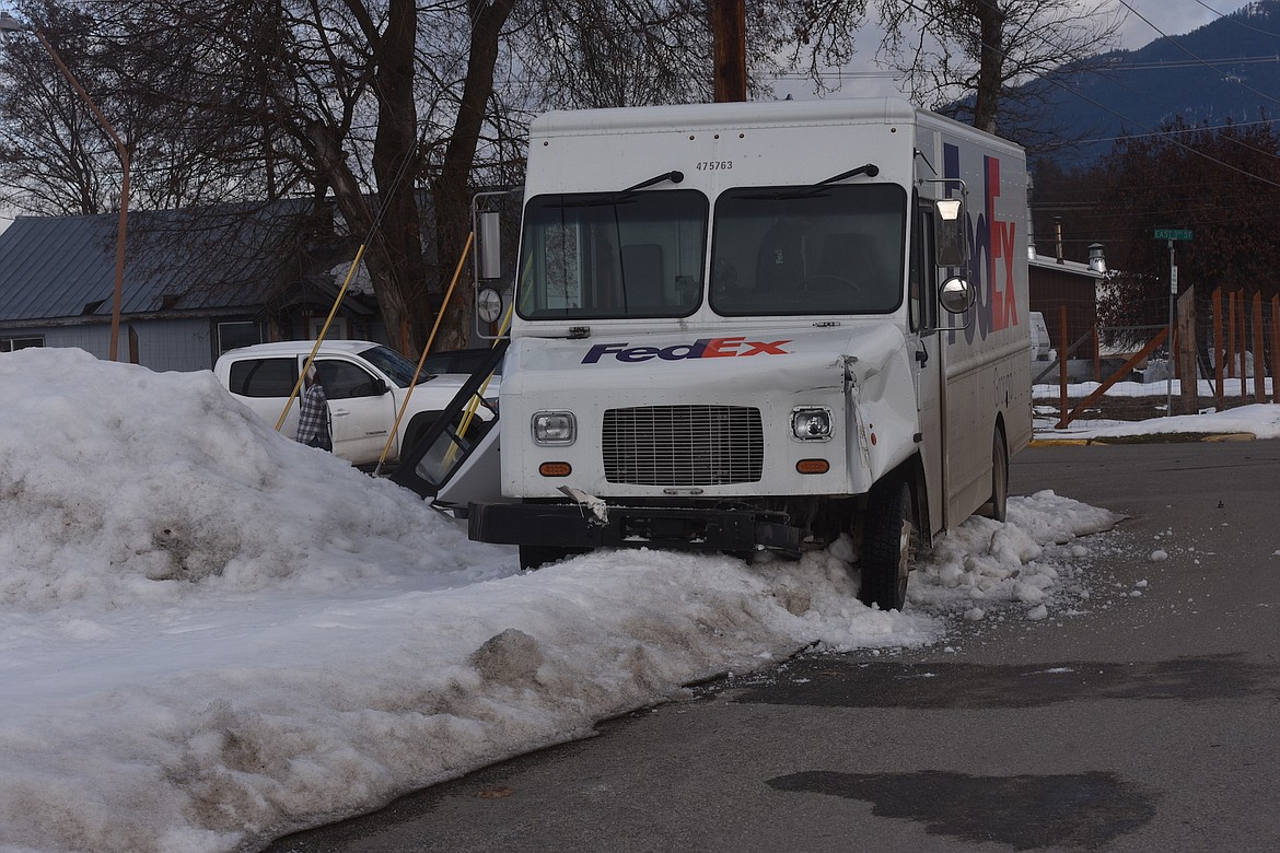 A FedEx delivery truck sits at the intersection of E. Third St. and Montana Ave. Thursday morning. The FedEx truck collided with a white Toyota Tacoma. There were no serious injuries reported and an officer from the Lincoln County Sheriff’s Office was the first to respond. (Scott Shindledecker/The Western News)