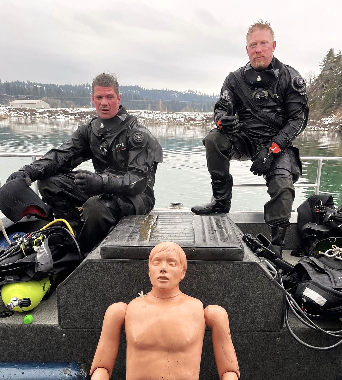 (left) Neal Dyer and Caleb Watts participate in dive training retrieving weighted dummy.