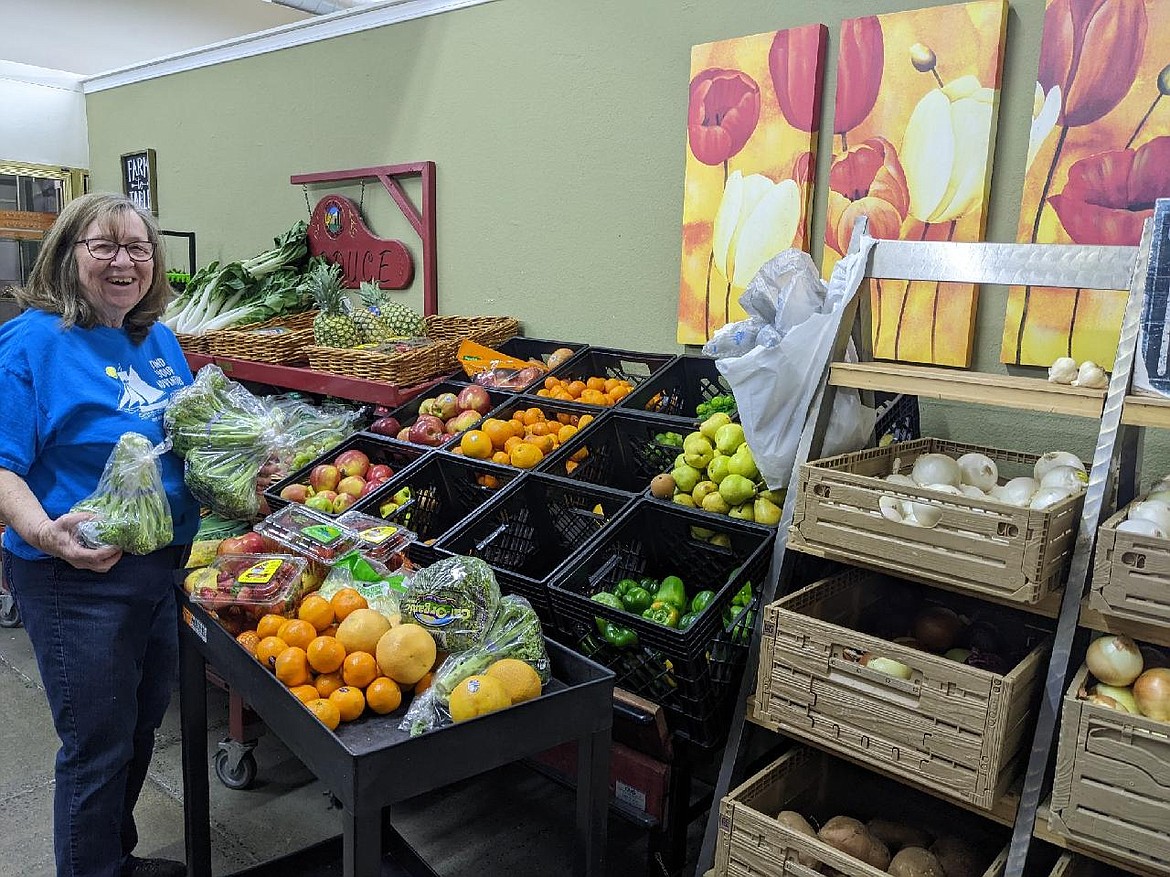 Volunteer Linda Fox stocks the produce section in the Post Falls Food Bank's Third Avenue Market. The food bank is one of nearly 20 nonprofits to receive a portion of $150,000 distributed by United Way of North Idaho through its Community Care Fund.