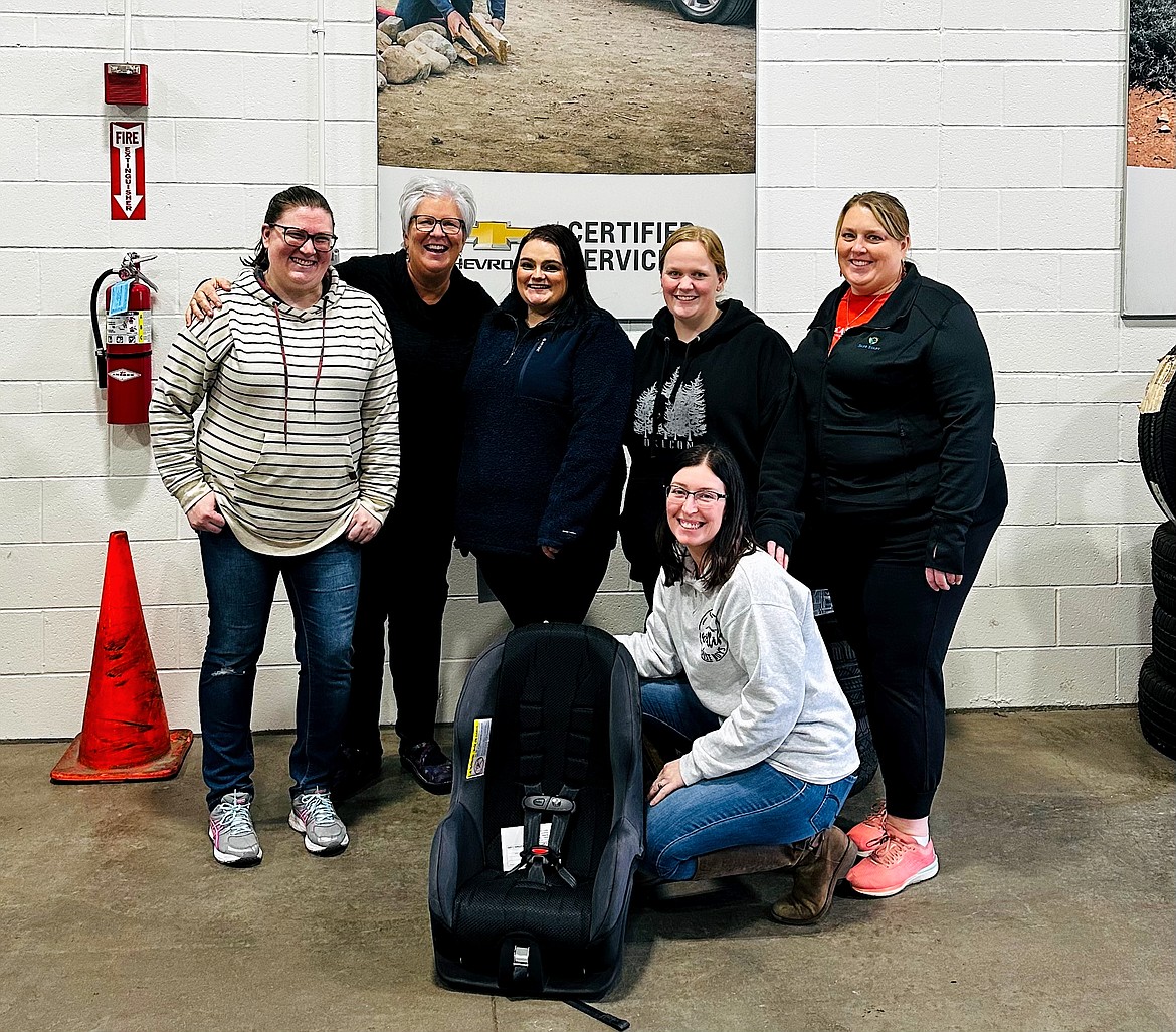 Northwest Infant Survival and SIDS Alliance volunteer child passenger safety technicians are seen at a car seat check event. From left: Kendra Harrison, Suzanna Spencer, Amanda Kirk, Ashley Crosby (also board member) and Executive Director Liz Montgomery, with board member Cherie Patterson kneeling in front. Safe Start is a recipient of a portion of United Way of North Idaho's Community Care Fund grant money.