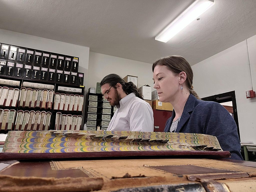 Sociocultural Anthropologist and Racial Covenants Project Director Dr. Tara Kelly of Eastern Washington University and Research Associate Colton Schons look over historical records of property in Eastern Washington as part of their work on the project which seeks to identify where race restrictions would have prevented minorities and others from purchasing homes in certain neighborhoods.