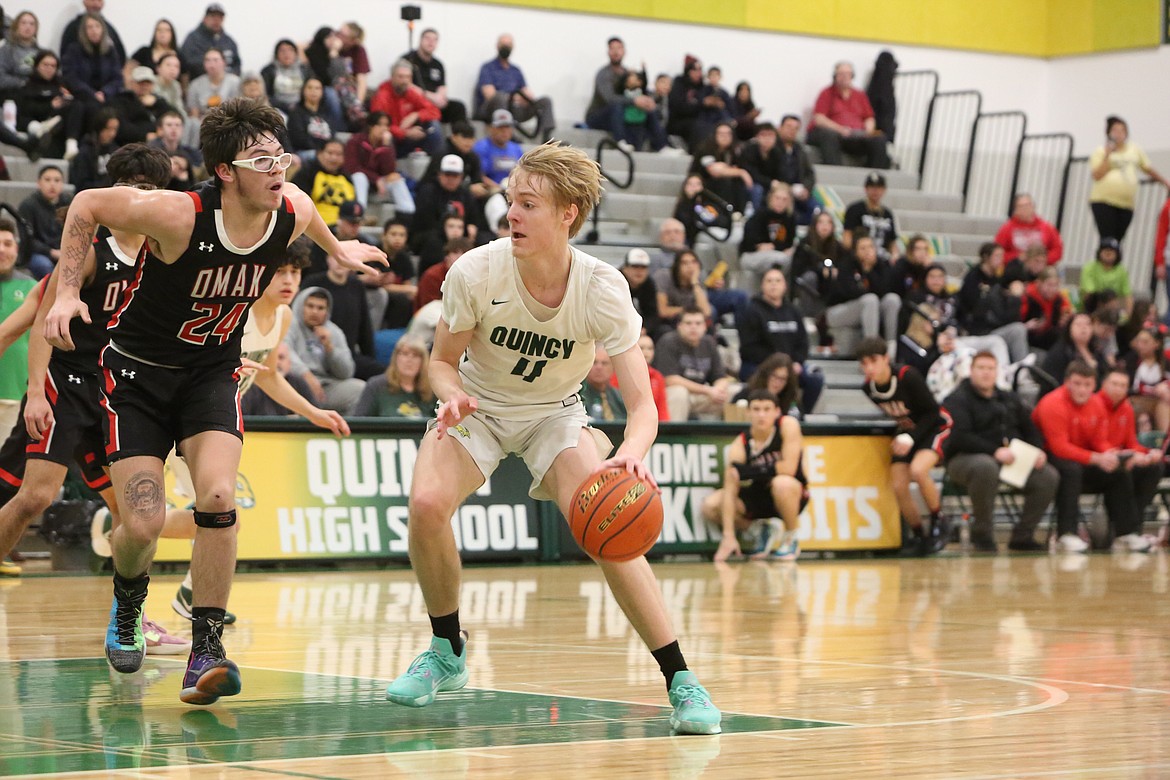 Quincy junior Aidan Bews (4) drives to the rim during the Jackrabbits’ 83-74 win over Omak on Tuesday. Bews was the lone returning starter for the Jacks this season, and has helped guide Quincy to a league title.