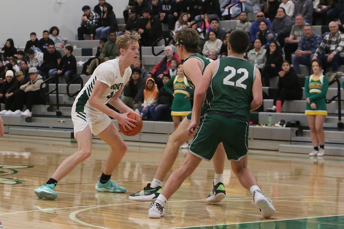 Quincy’s Aidan Bews looks past two Chelan defenders for an open teammate during the second half of the Jackrabbits’ 83-81 win over the Mountain Goats on Jan. 3.