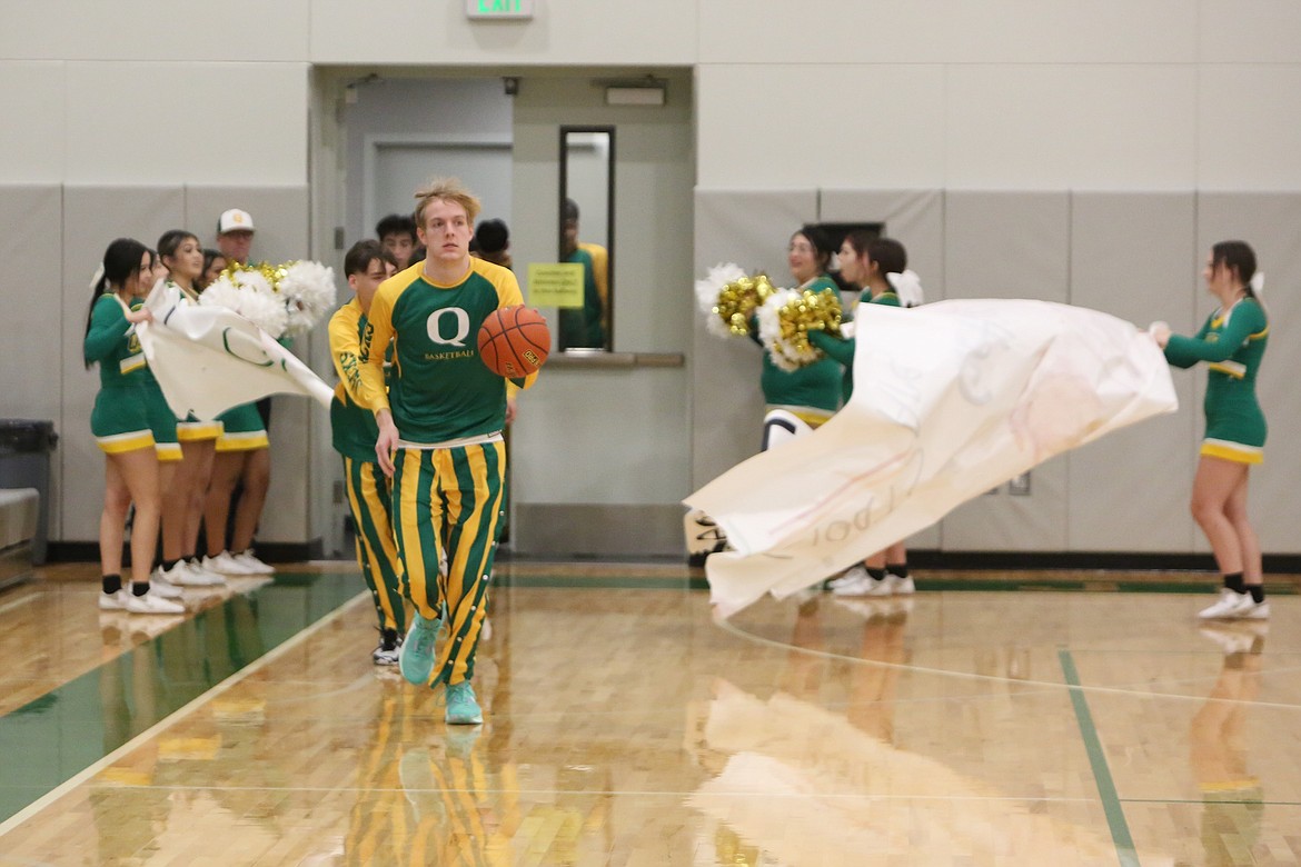 Quincy junior Aidan Bews, foreground, leads the team onto the court against Chelan. Bews has transitioned into the team’s top offensive option, averaging 20.7 points per game and shooting 51% from the field and 44% from three.