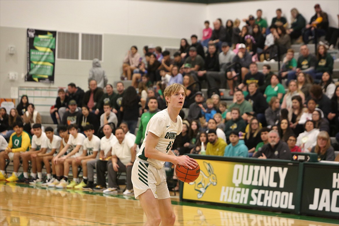 Standing behind the three-point line, Quincy’s Aidan Bews looks to take a shot against Omak.