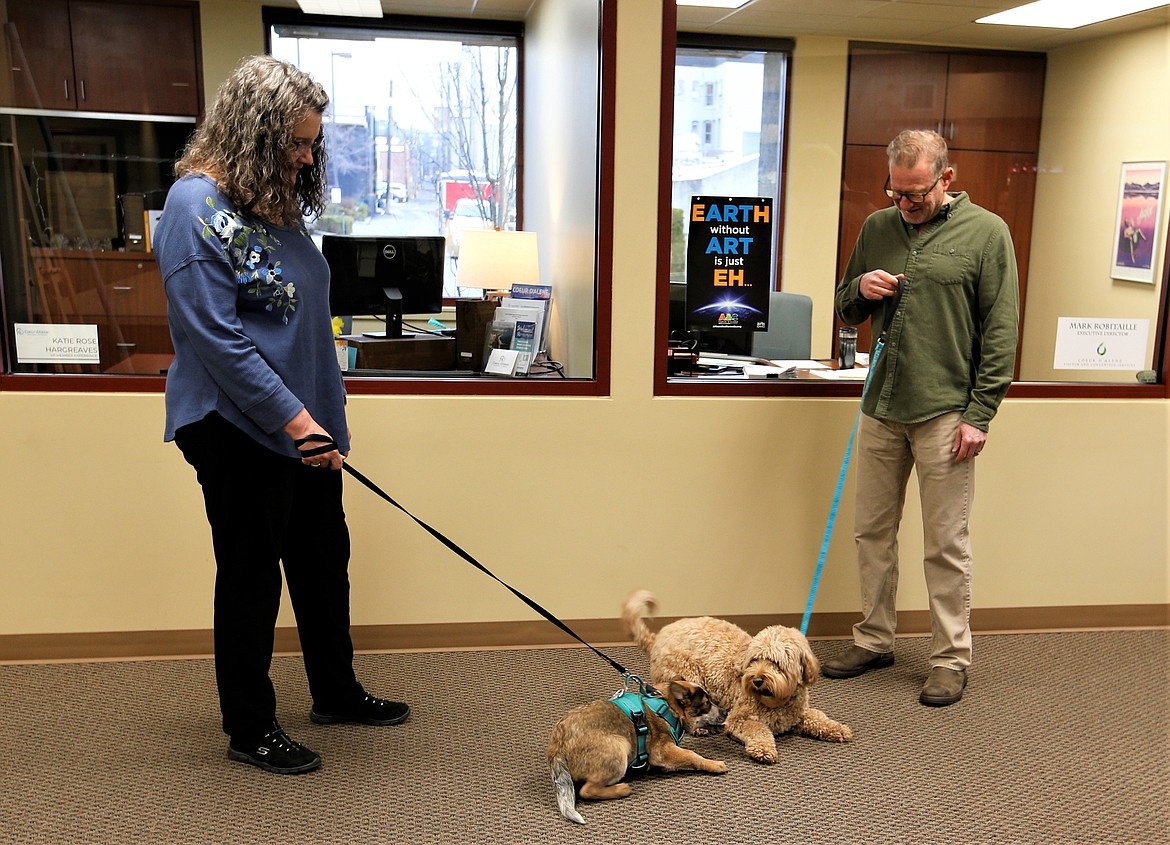 Mark Robitaille with the Coeur d'Alene Convention & Visitor Bureau and his dog Molly share greetings with May Thompson-Lehto and Floyd at the Coeur d'Alene Regional Chamber.