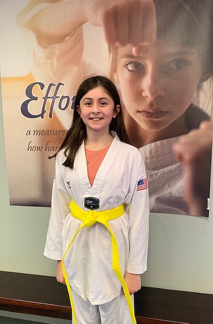 Elena de Basilio posing after successfully testing for her yellow belt.