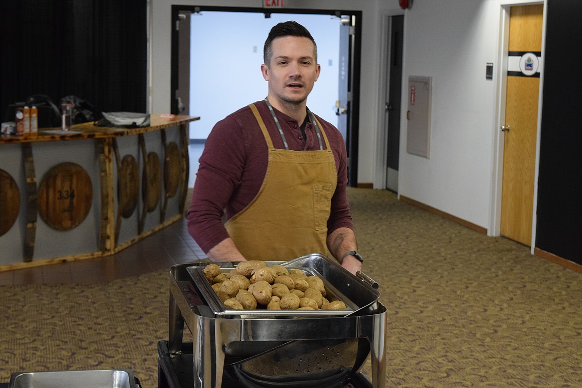 Professional Chef Ben Leonard prepares to hand out roasted potatoes at the start of a class on how to make gnocchi at the 2023 Washington-Oregon Potato Conference on Thursday. “I feel like a flight attendant pushing this cart around,” Leonard said.