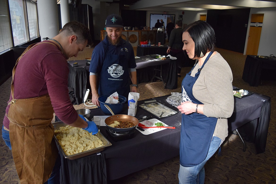 Chef Ben Leonards adds gnocchi to the mushroom saucepan of Othello resident Zack Garza and Moses Lake resident Jennica Heffop.