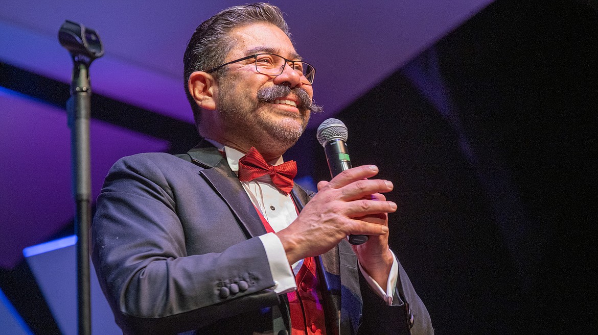 Cardinal Voices Director Max Mendez speaks onstage during NIC’s Sounds of Christmas concert on Dec. 11 at Boswell Hall Schuler Performing Arts Center on NIC’s main campus in Coeur d’Alene.