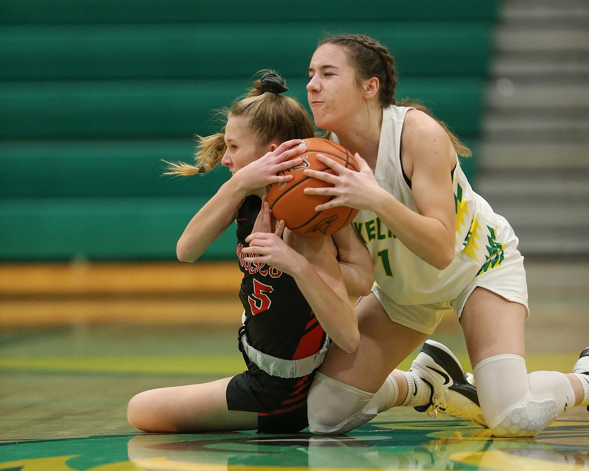 JASON DUCHOW PHOTOGRAPHY
Kolbi Kiblen (5) of Moscow and Karstyn Kiefer (1) of Lakeland wrestle for the ball Friday night at Hawk Court in Rathdrum.