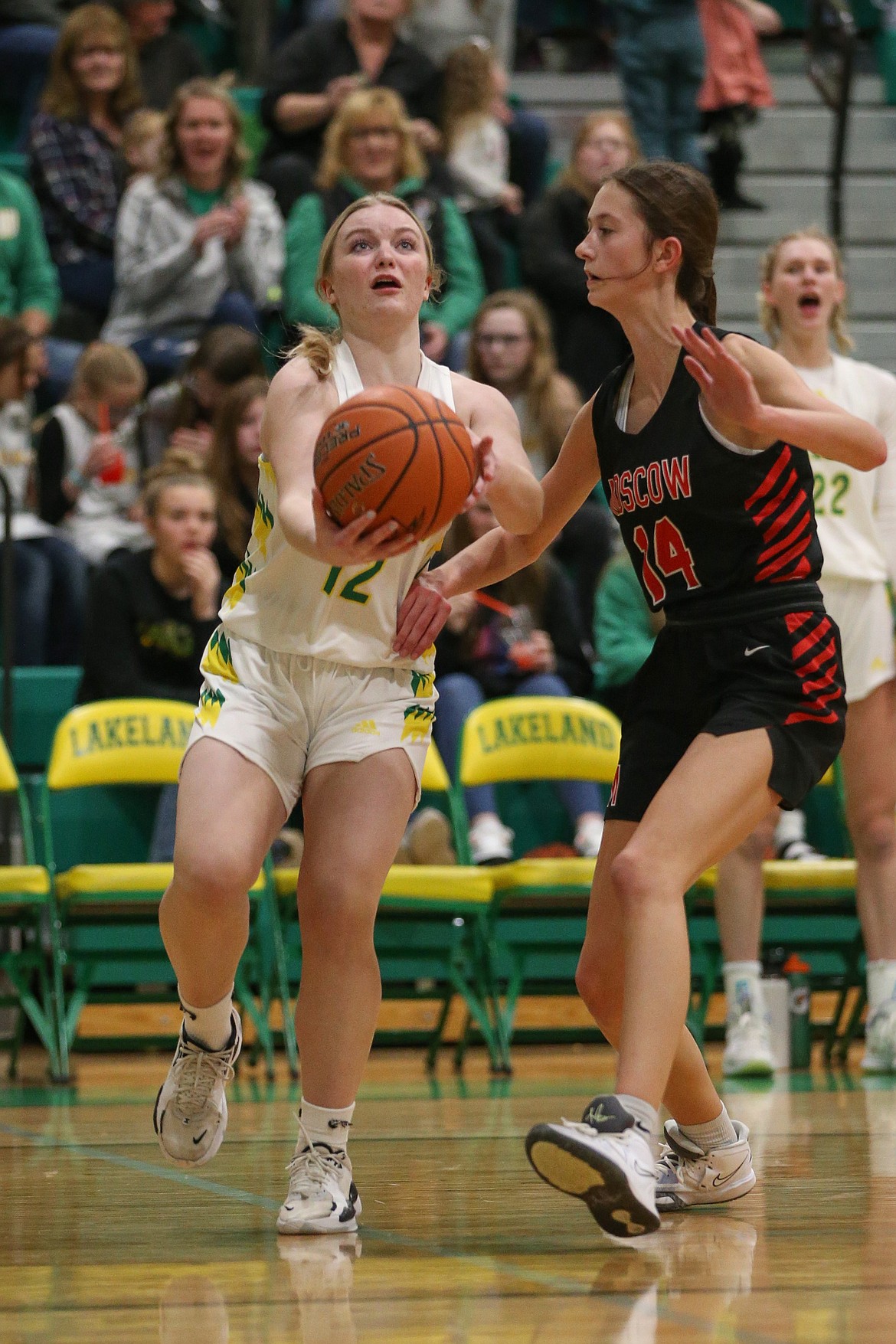 JASON DUCHOW PHOTOGRAPHY
Emily Knowles (12) of Lakeland puts up a scoop shot as Taylor McLuen (14) of Moscow defends Friday night at Hawk Court in Rathdrum.