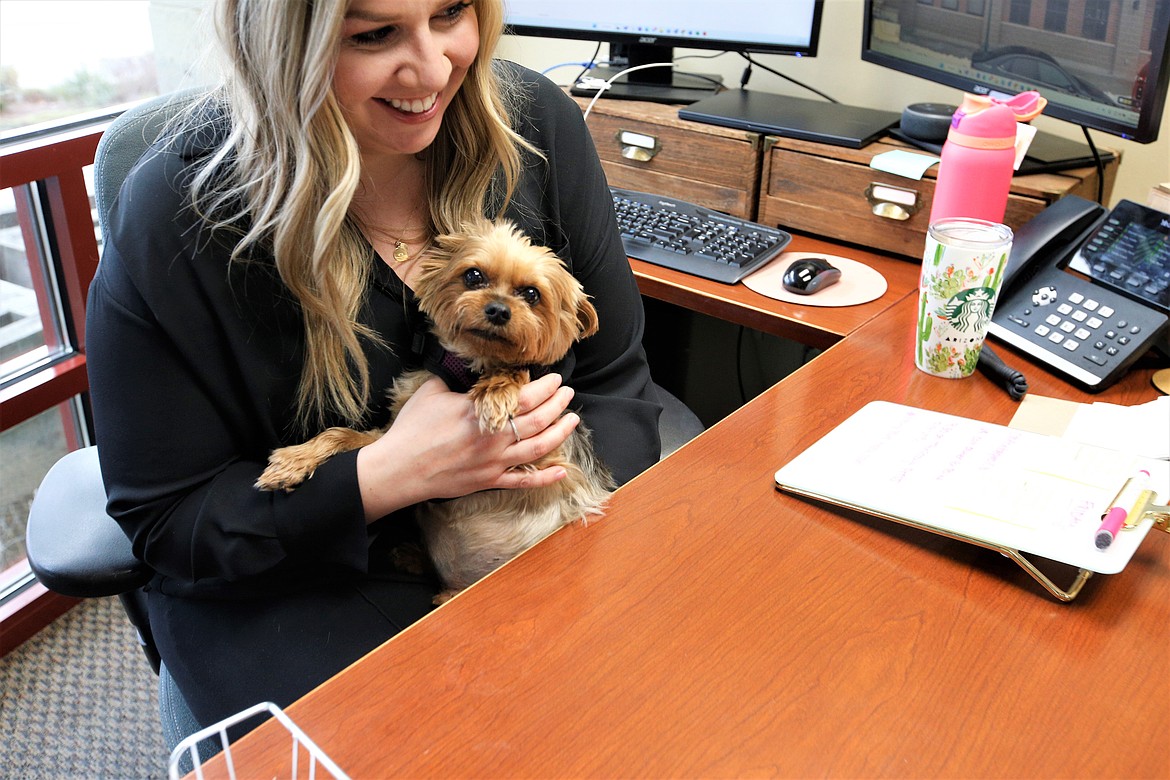 Emily Boyd, executive director of the Coeur d'Alene Downtown Association, holds Finley in her office at the Coeur d'Alene Regional Chamber on Thursday.