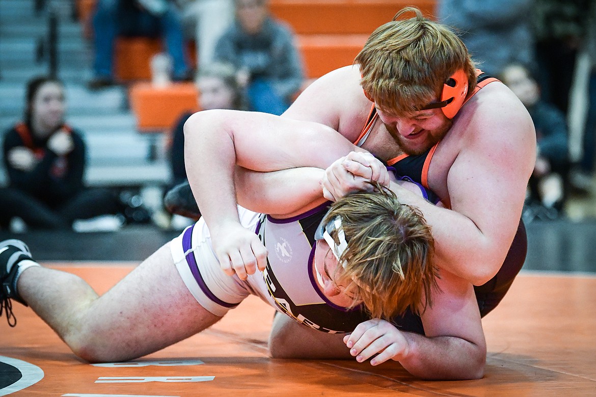 Flathead's Forest Howell wrestles Missoula Sentinel's Brayden Wallace at heavyweight at Flathead High School on Saturday, Jan. 28. Howell won by decision 4-2. (Casey Kreider/Daily Inter Lake)