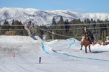 A snowboarder clears a jump at the Whitefish Skijoring competition on Saturday, Jan. 28 in Columbia Falls. The action continues Sunday from noon to 4 p.m., with an awards ceremony following at the Blue Moon. (JP Edge/Hungry Horse News)