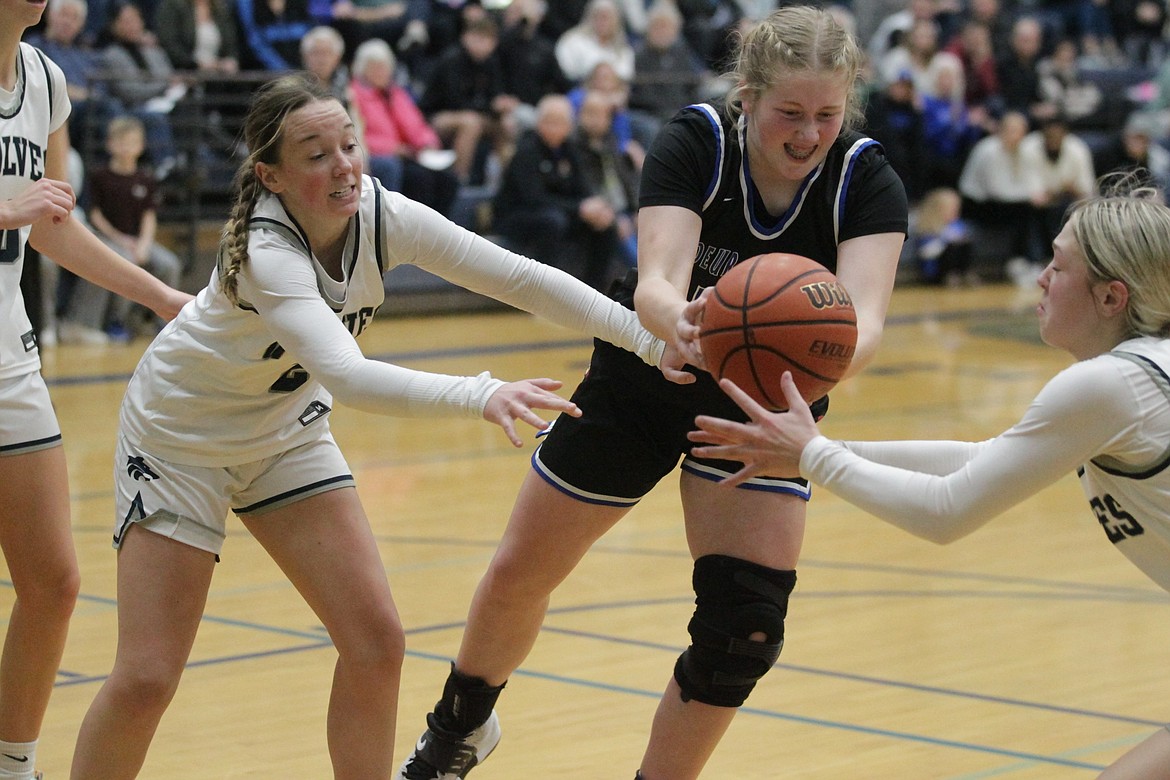 MARK NELKE/Press
From left, Kamryn Pickford of Lake City, Kelsey Carroll of Coeur d'Alene and Sophia Zufelt of Lake City reach for a loose ball Saturday at Lake City.