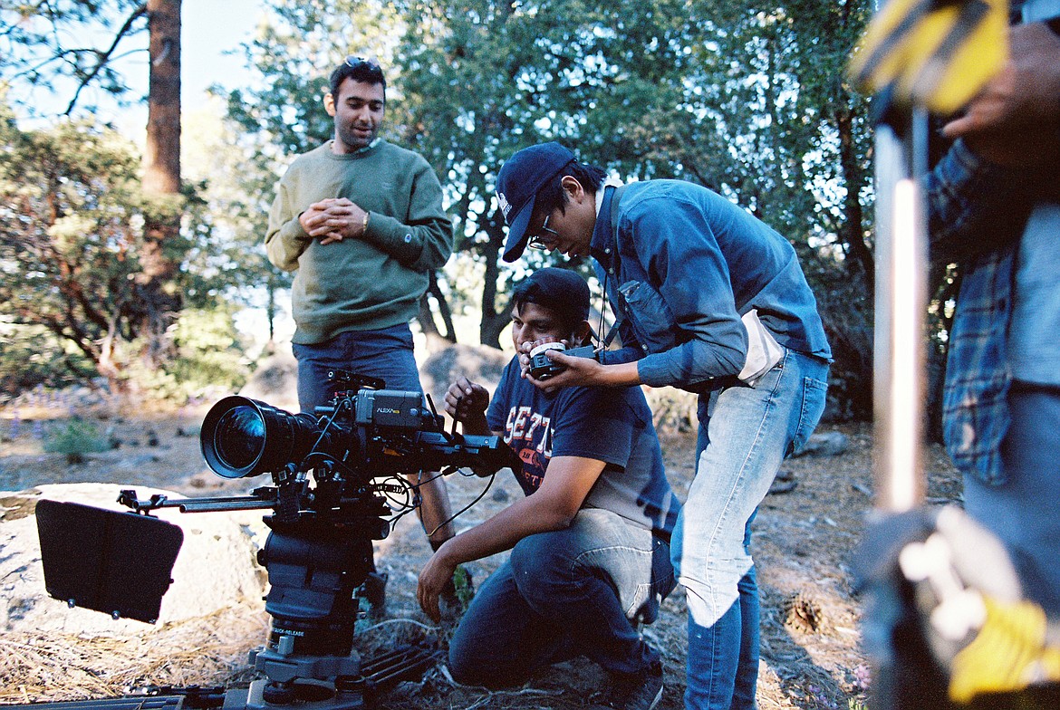 Keon Hedayati, left, watches crew film a scene from his new independent movie, "Karma Bums".