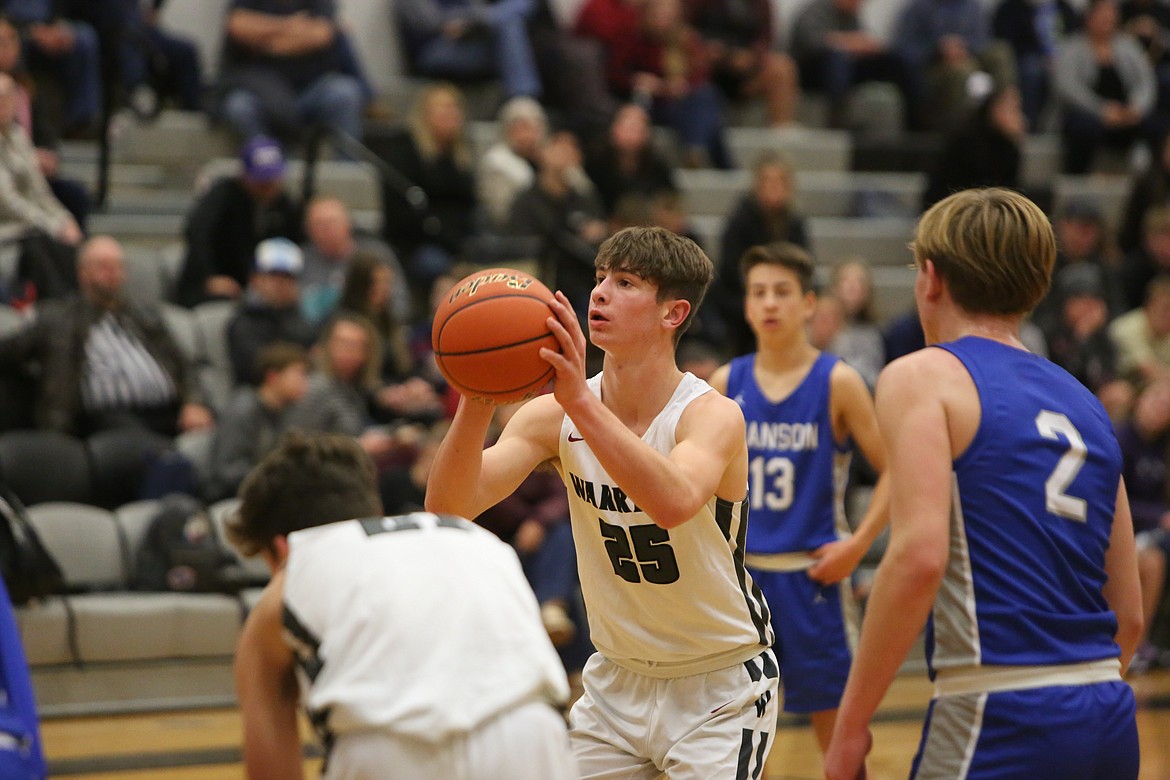 Almira/Coulee-Hartline’s Max Grindy, an eighth-grader, shoots a free throw against Manson. Grindy is one of the numerous young players on the Warrior roster this season.